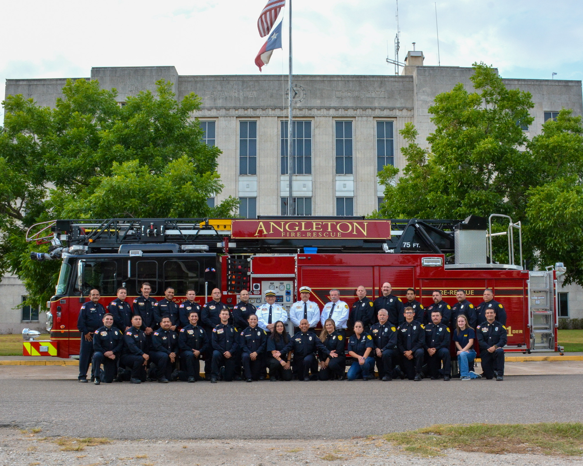 Angleton Firefighters with Firetruck Members of the Angleton Volunteer Fire Department posing alongside a firetruck.