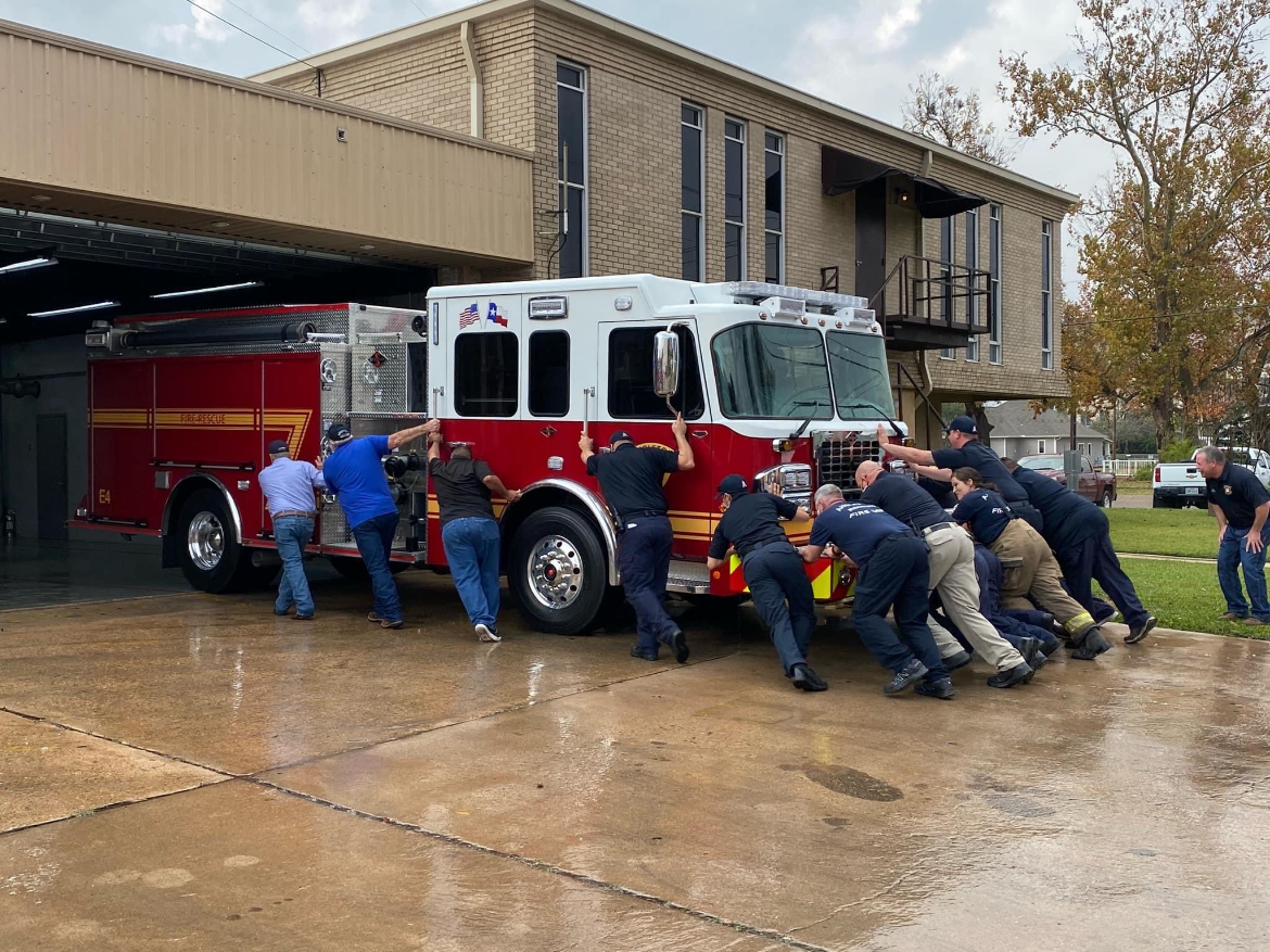 Firefighters Pushing Firetruck Angleton Volunteer Firefighters pushing a firetruck back into the firehouse.
