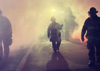 Angleton Volunteer Firefighters responding to an accident scene shrouded in smoke.