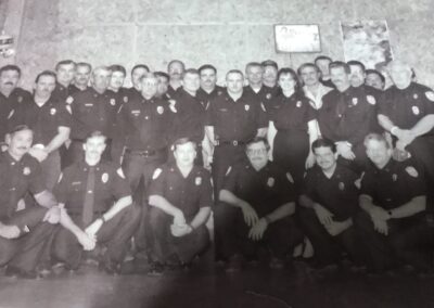 Firefighters posing in dark uniforms to keep the record of the department's history alive.