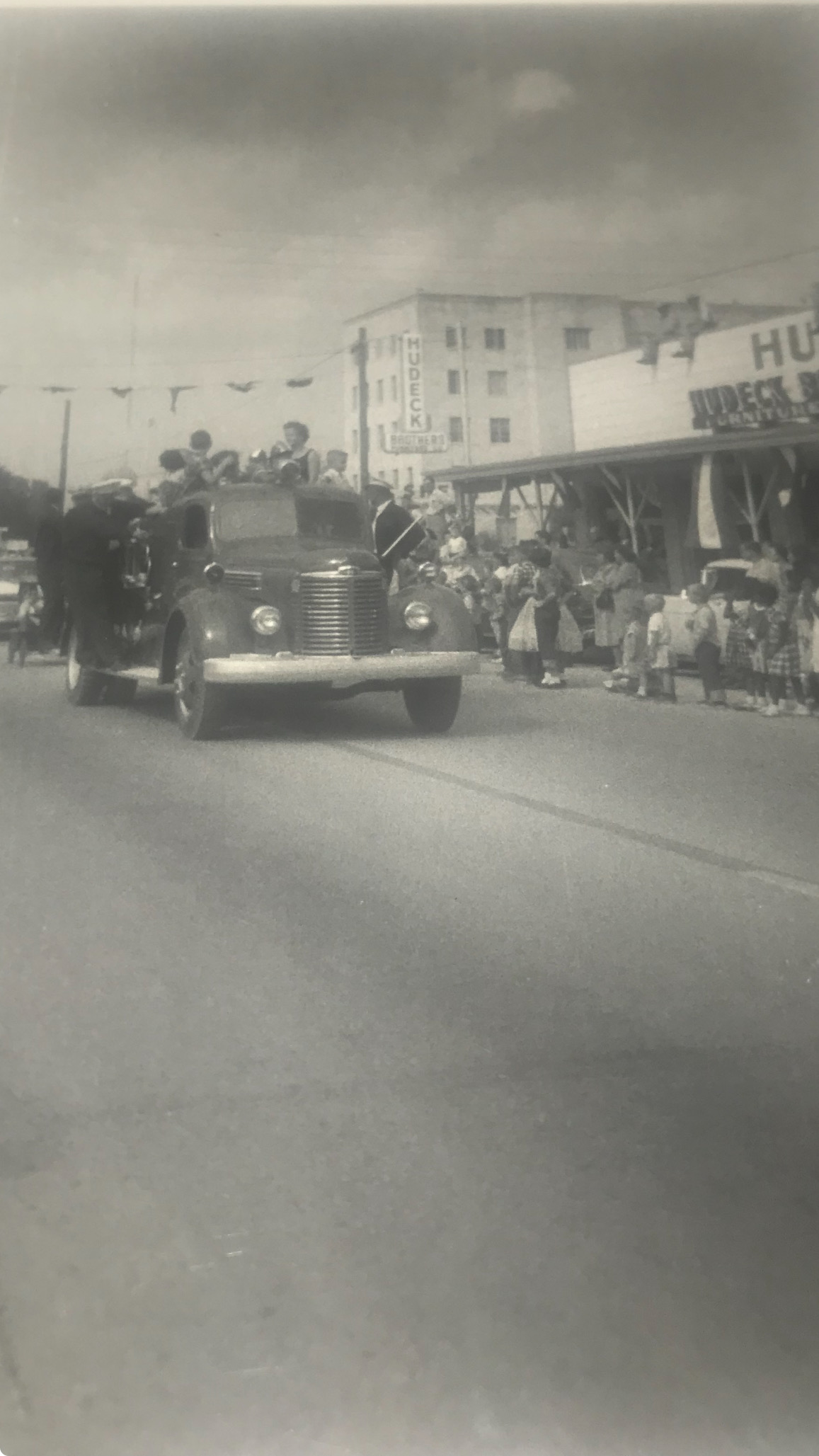 Old Firetruck in Angleton Parade An Angleton Volunteer Fire Department firetruck in a parade from long ago to highlight our history.